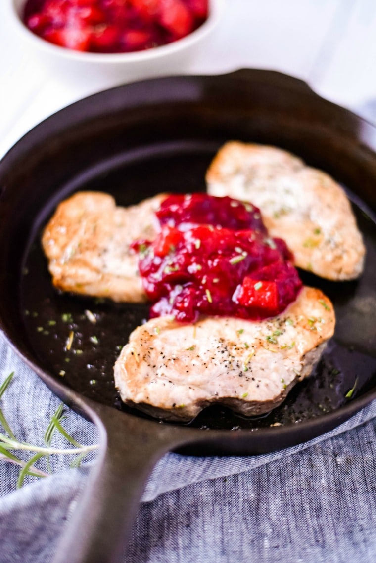 Apple Cranberry Sauce on Pork Chops in Cast Iron Skillet