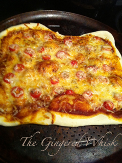 homemade freshly baked pizza on baking sheet