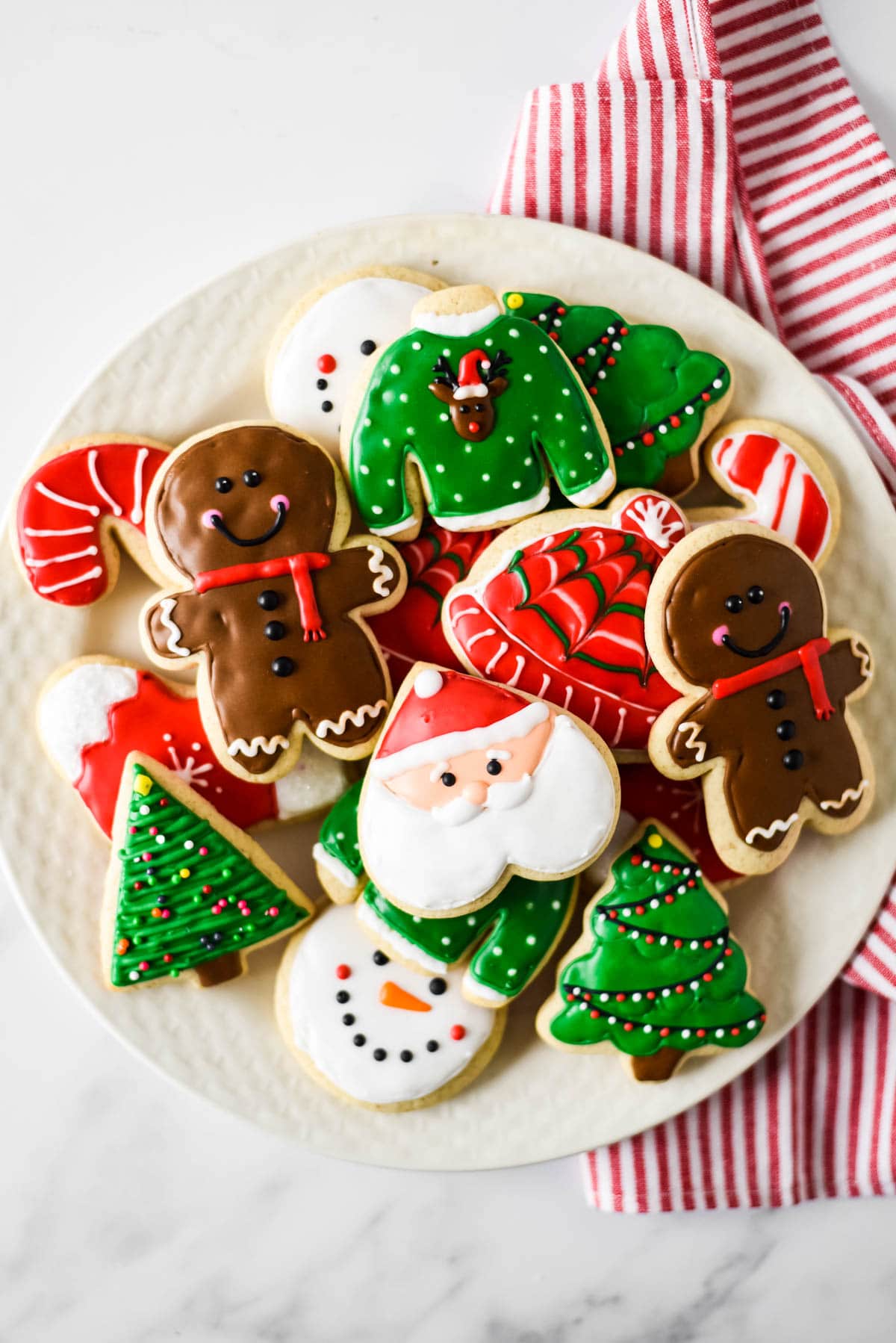 close up overhead view of white plate with christmas sourdough sugar cookies on top