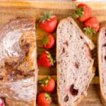 sourdough strawberry bread cut in half with strawberries